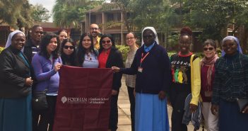 A group photo of several Kenyan nuns, GSE students, and staff