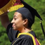 Jamez Amour Anderson carrying the Fordham banner during procession.