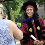 A graduate posing for a photo.