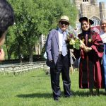 A GSE graduate posing for a photo with two family members.